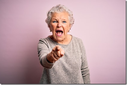 Senior beautiful woman wearing casual t-shirt standing over isolated pink background pointing displeased and frustrated to the camera, angry and furious with you