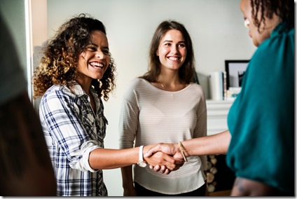 Diverse woman shaking hands